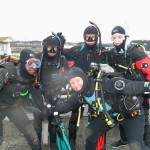 Group of scuba divers preparing for dive adventure.