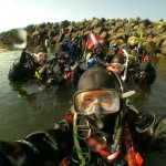 Group of scuba divers preparing for underwater adventure.