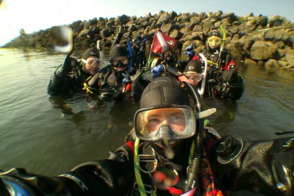 Group of scuba divers preparing for underwater adventure.