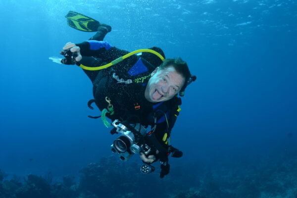 Scuba diver underwater with camera