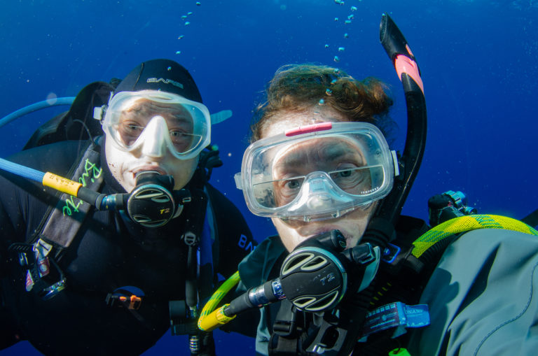 Two scuba divers underwater Drysuit Diving.