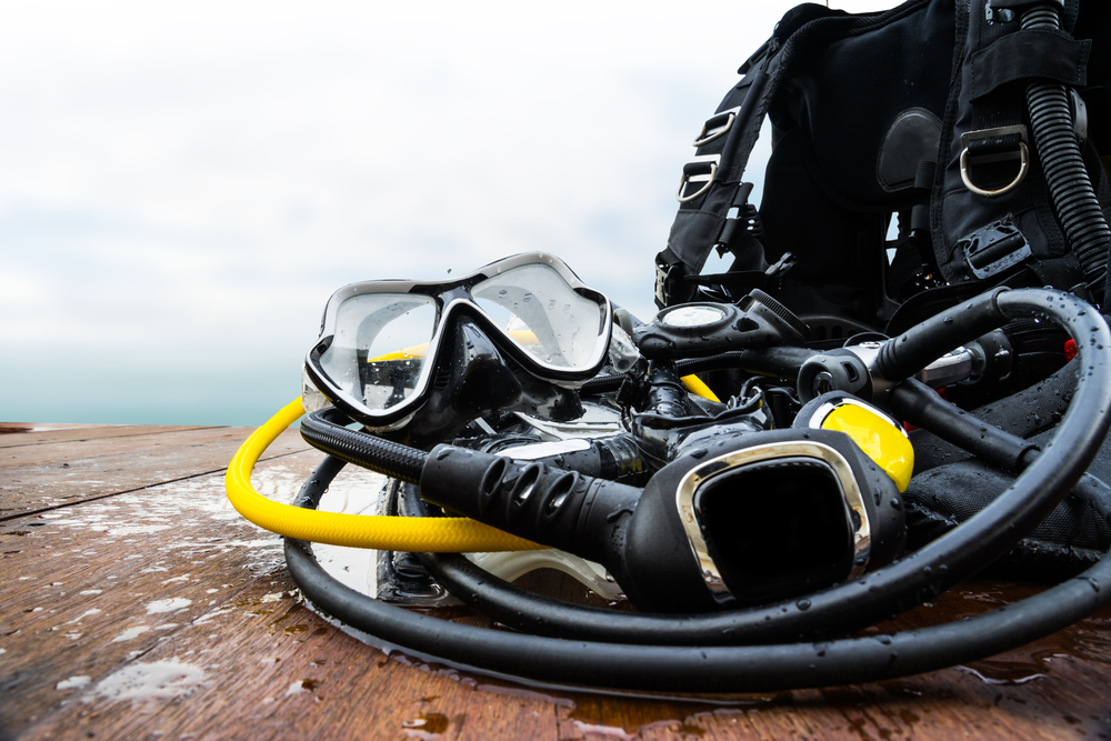 Scuba diving equipment on wooden deck