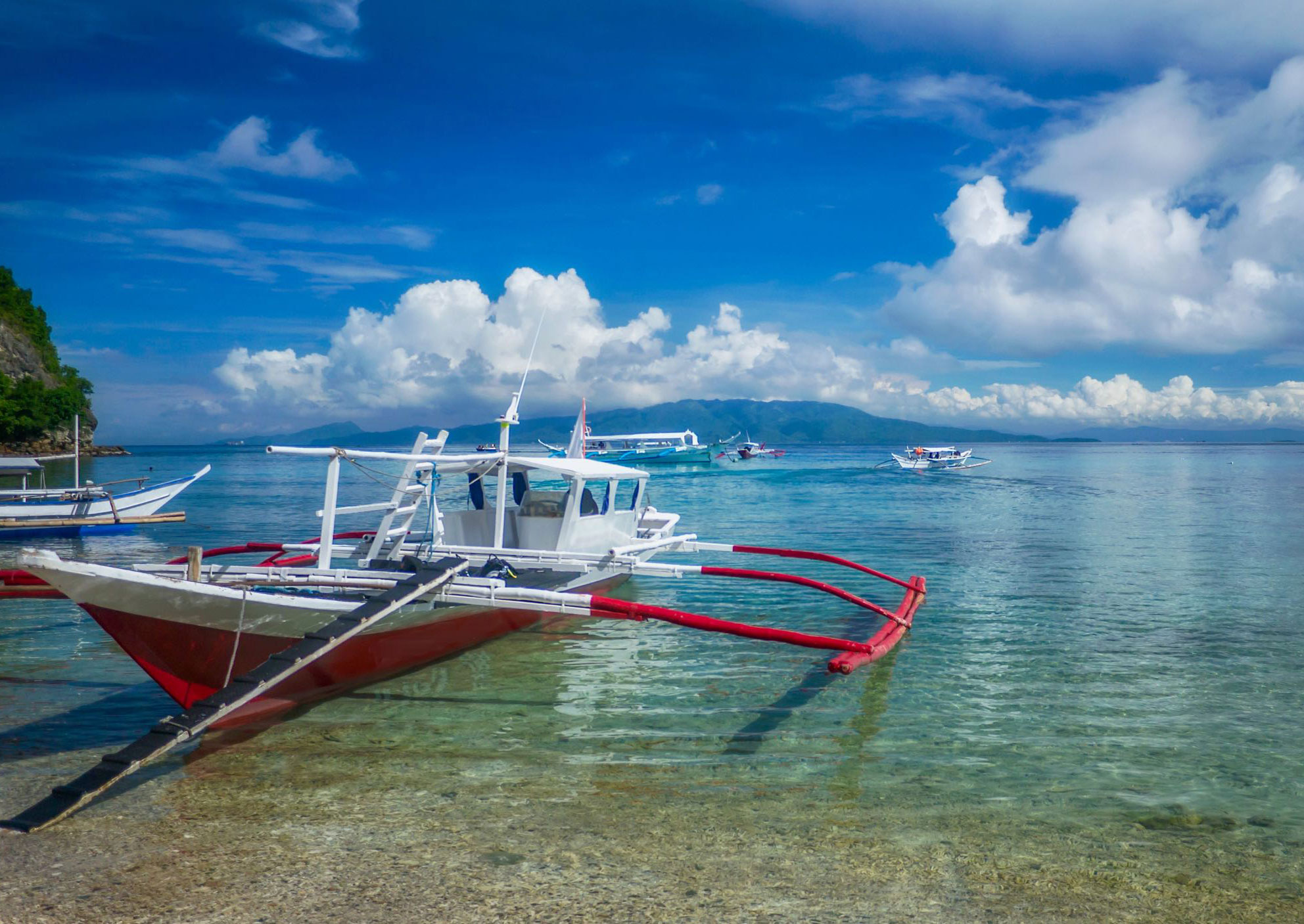 Traditional boats on clear tropical waters