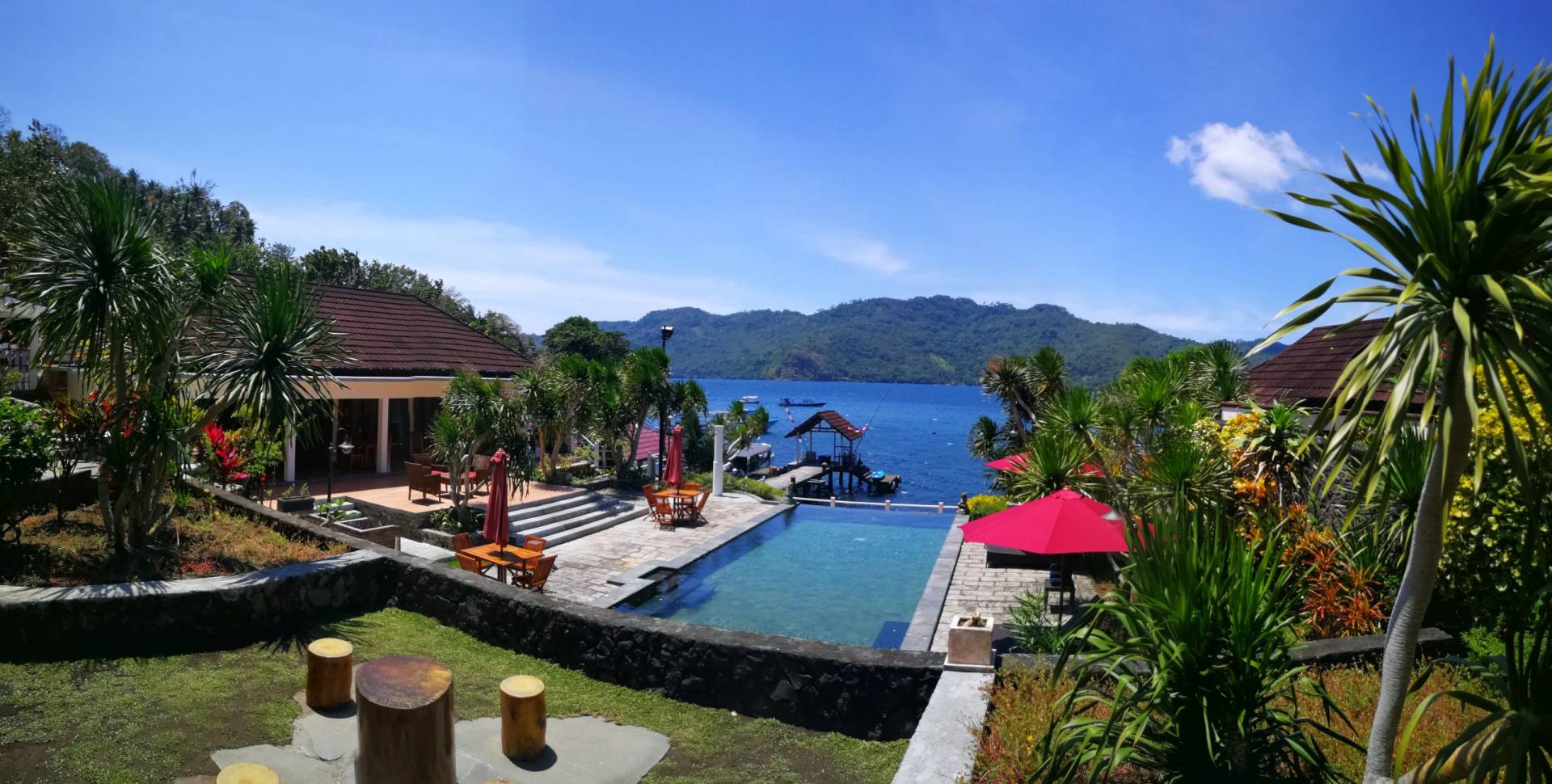 Tropical resort with pool and ocean view.