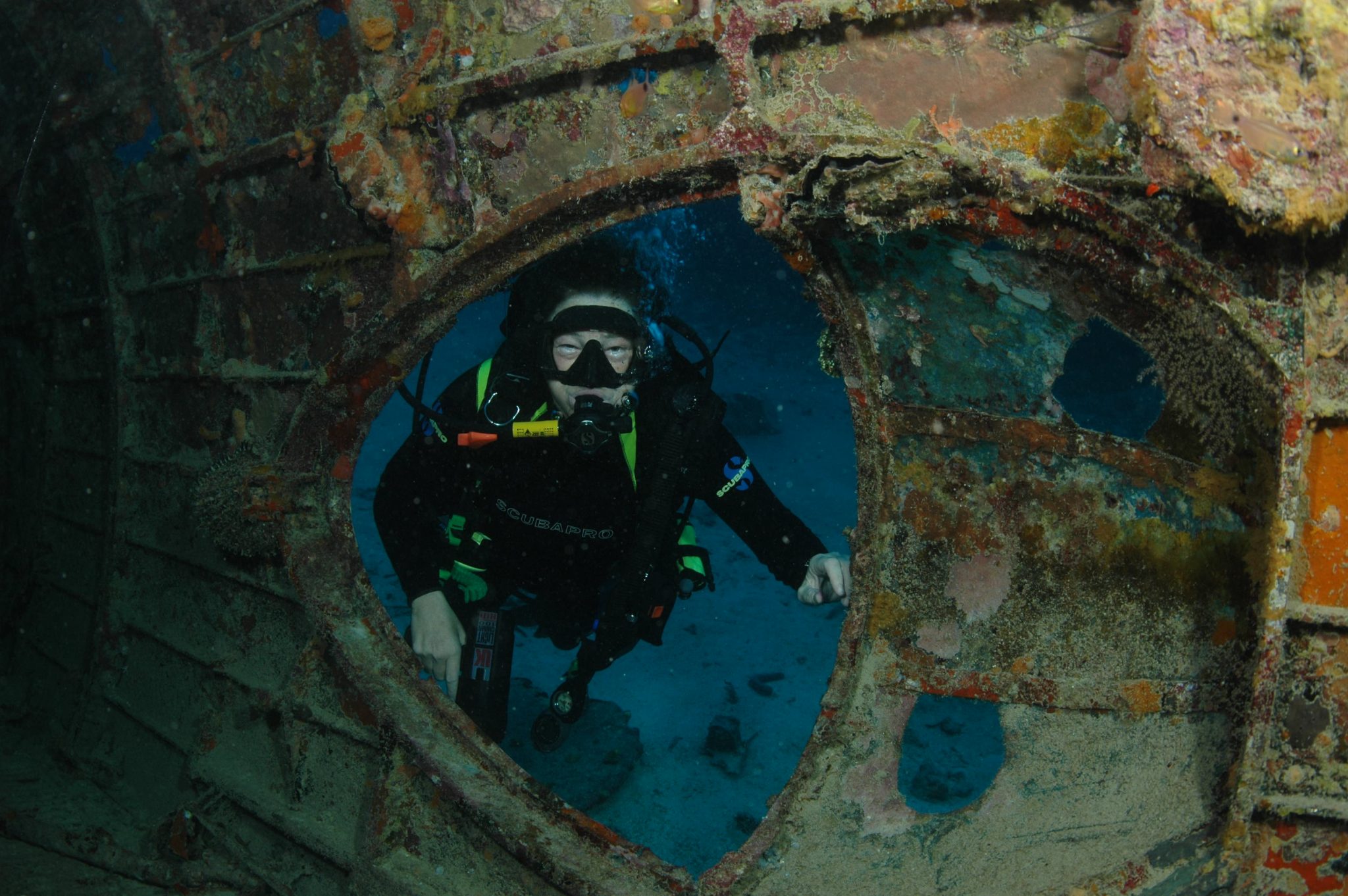 Diver exploring underwater shipwreck interior view