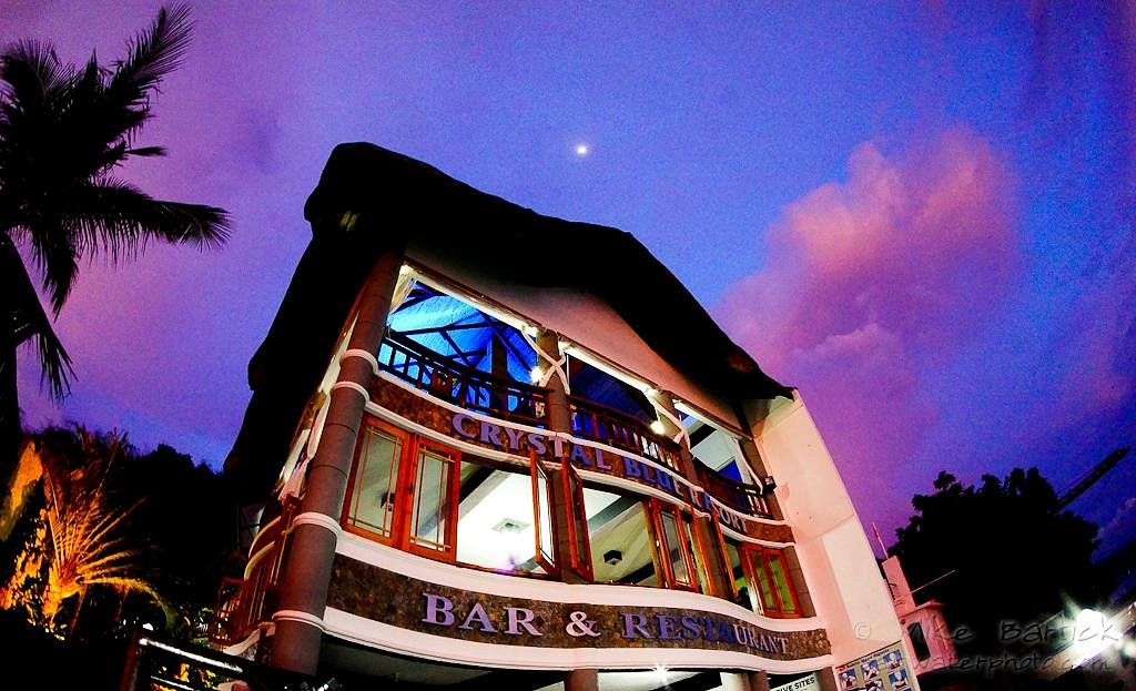 Colorful building at sunset with purple sky.